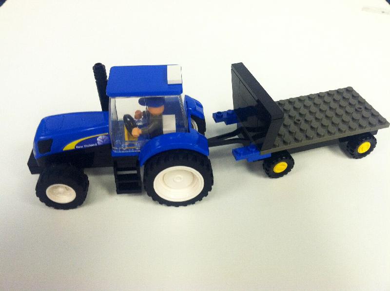 NEW HOLLAND TRACTOR WITH FLATBED TRAILER