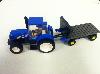 NEW HOLLAND TRACTOR WITH FLATBED TRAILER